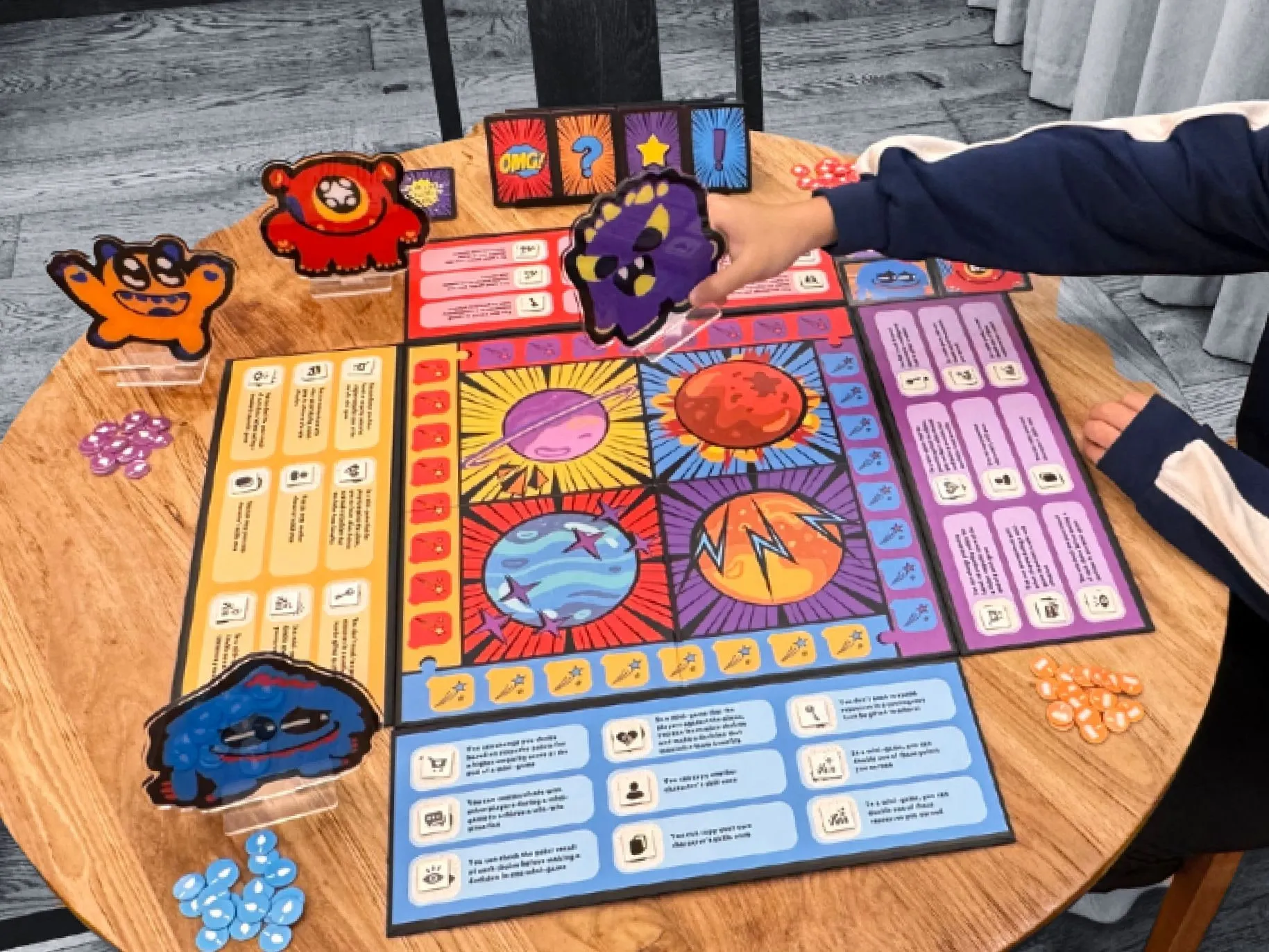 Product trial photo: a player places the purple character on a planet on the board